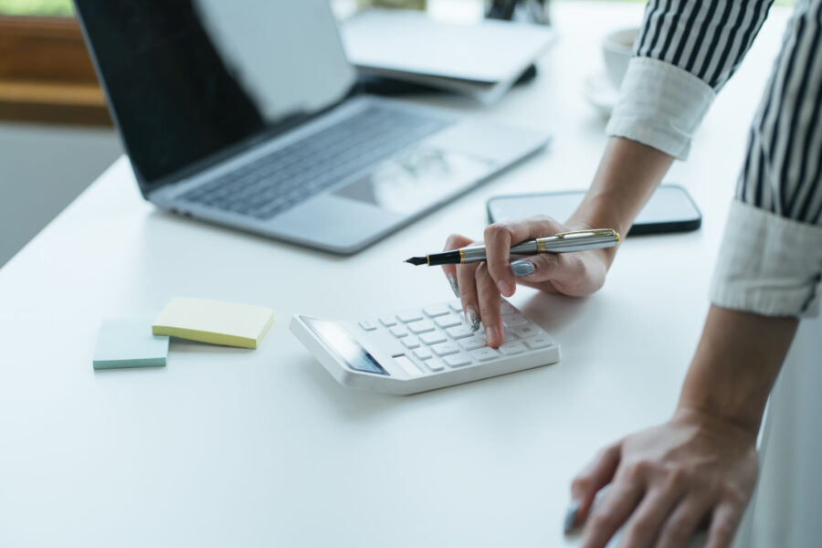 business woman hand calculating her monthly expens 2023 04 12 00 25 23 utc scaled e1688759570148