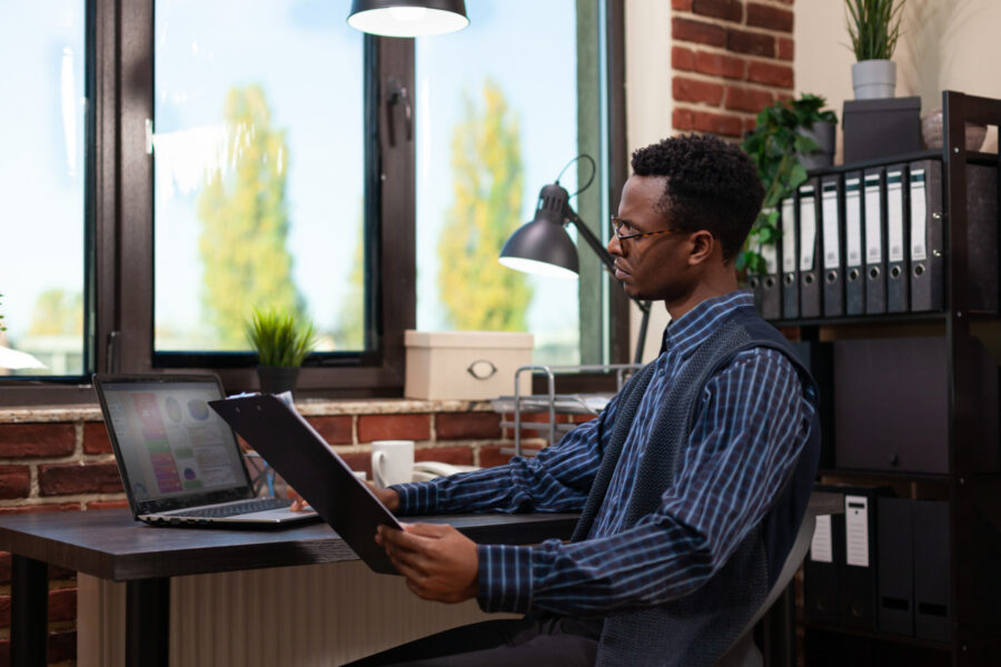 man developing pricing strategy on computer