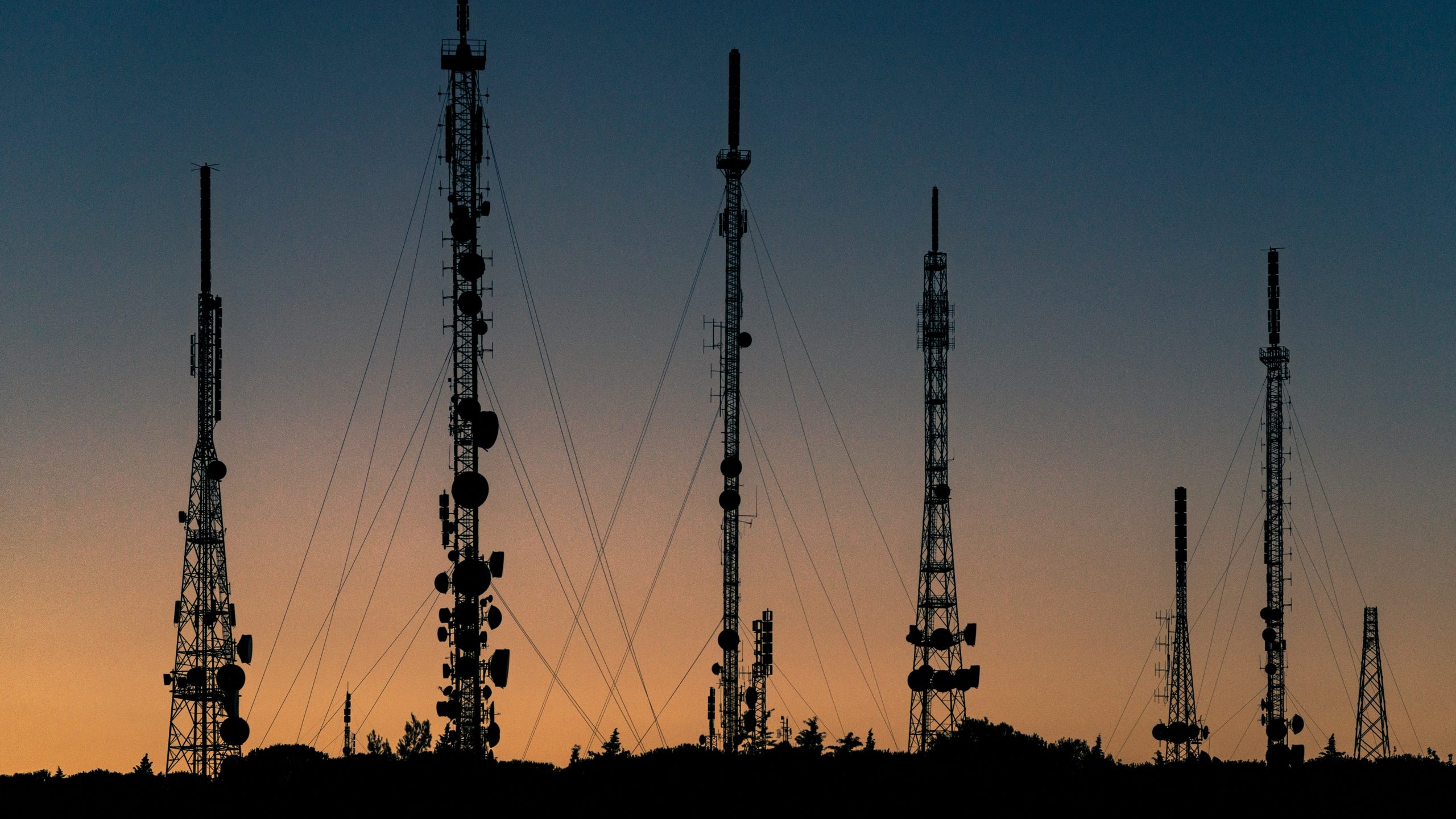 metal towers with sunset in background