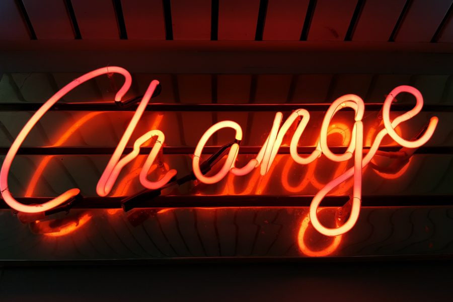 red neon glowing sign that says change