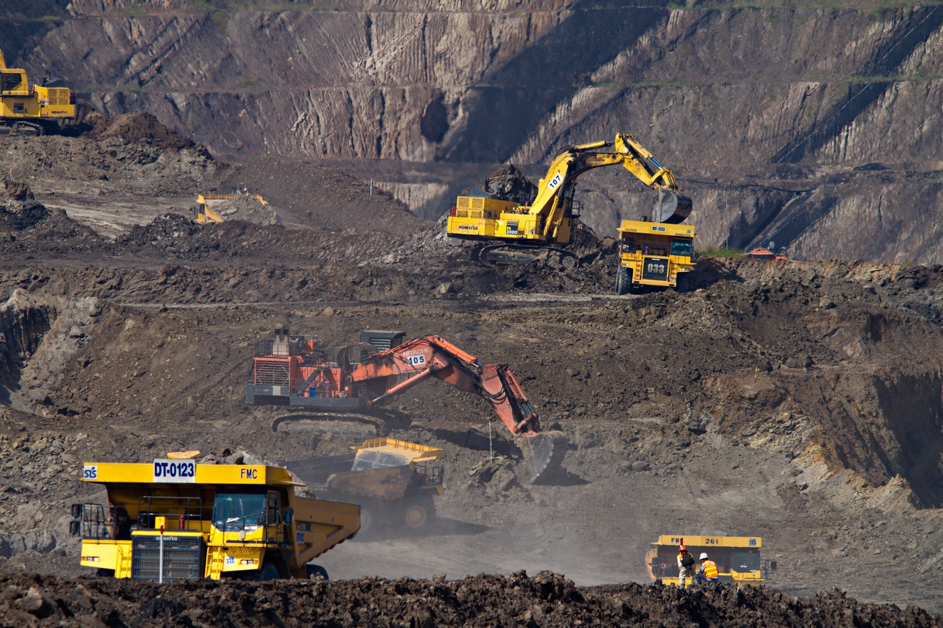 rental fleet of construction equipment actively working on dirt jobsite