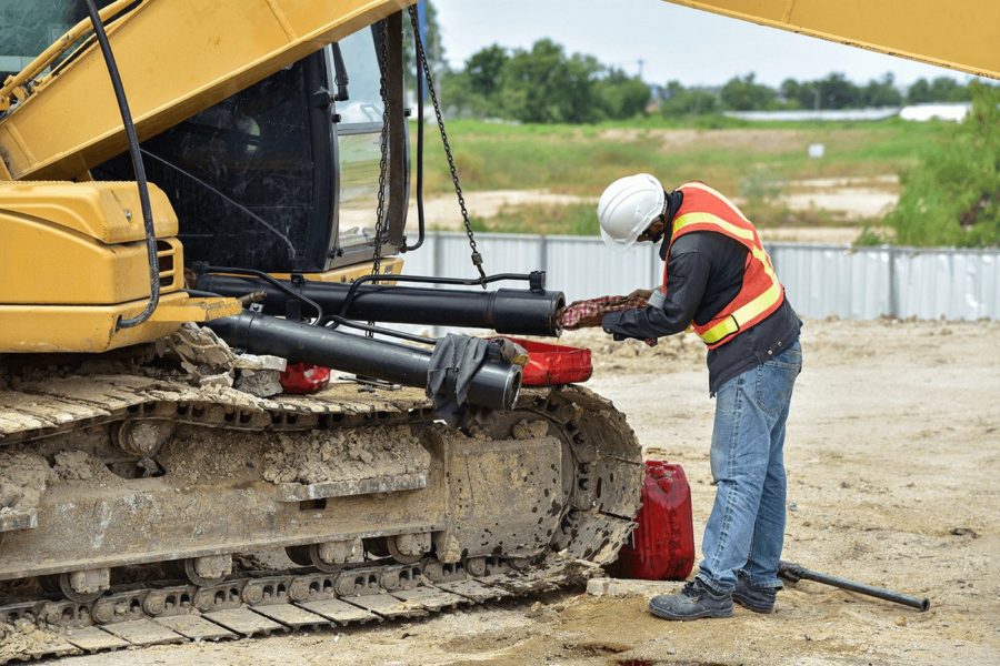 Construction worker servicing machine