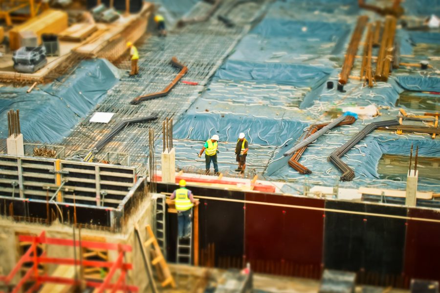 man in yellow safety vest climbing on ladder