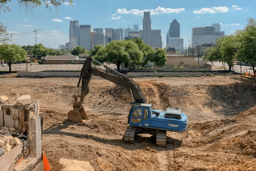 Blue excavator rental on dirt jobsite