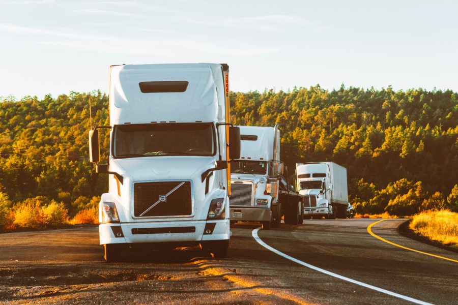 white volvo semi truck on side of road