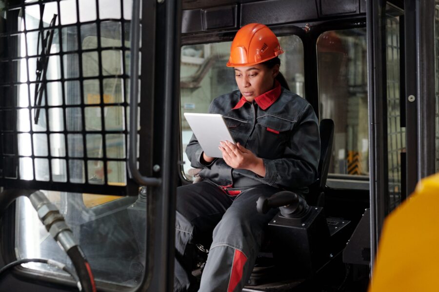 Female construction worker solving supply chain issues with digital tablet