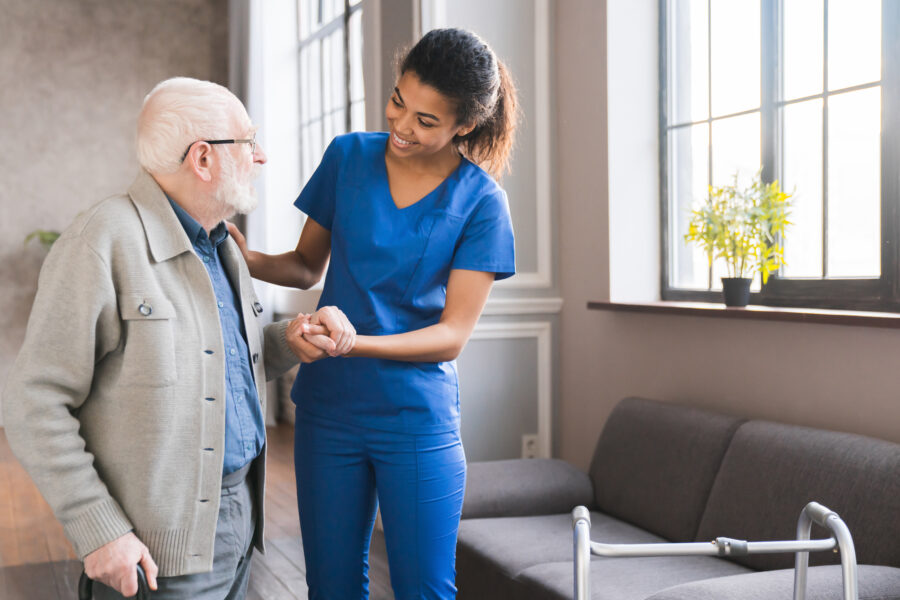 Hospice Nurse Helping Elderly Patient