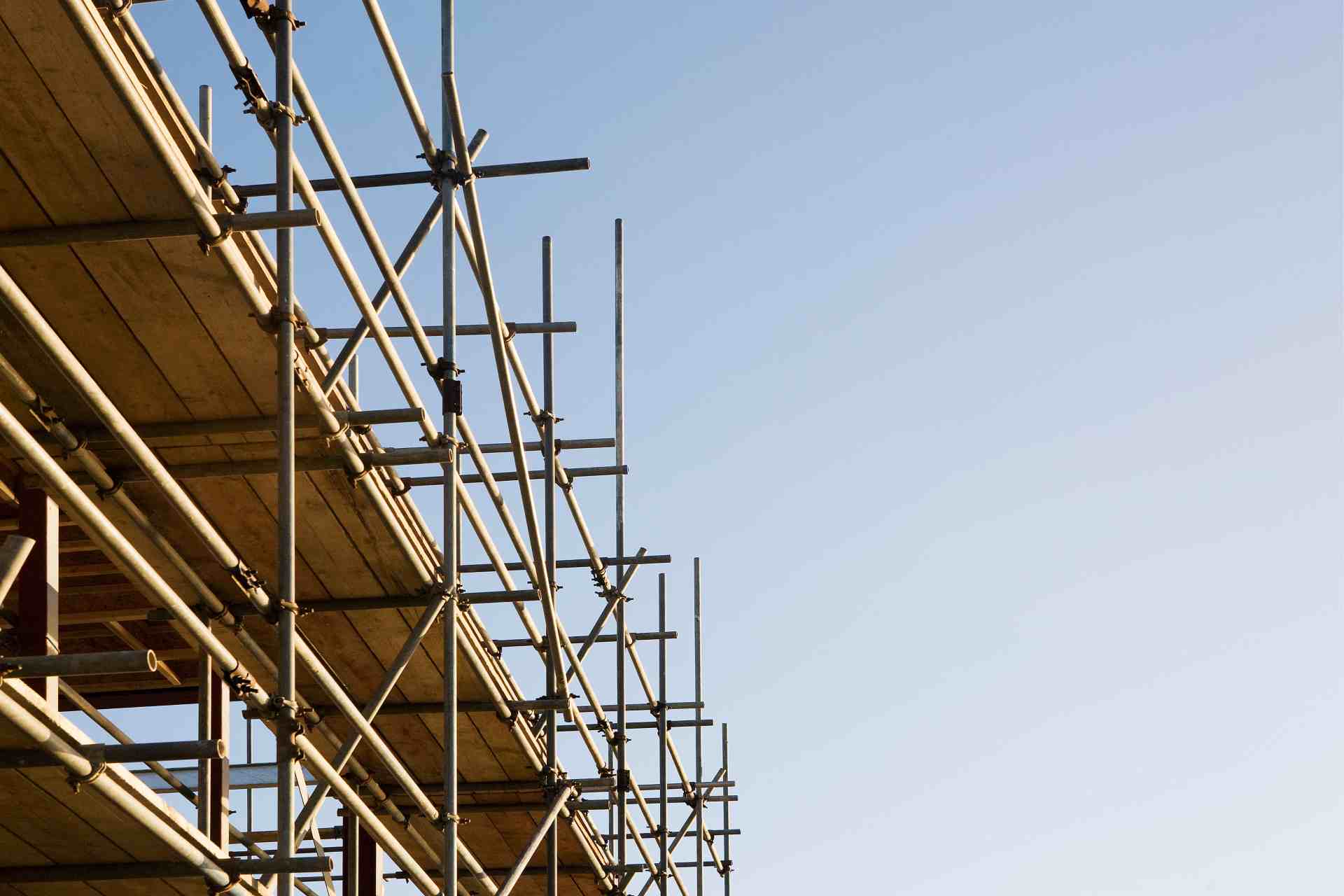 A close-up view of metal scaffolding against a clear sky