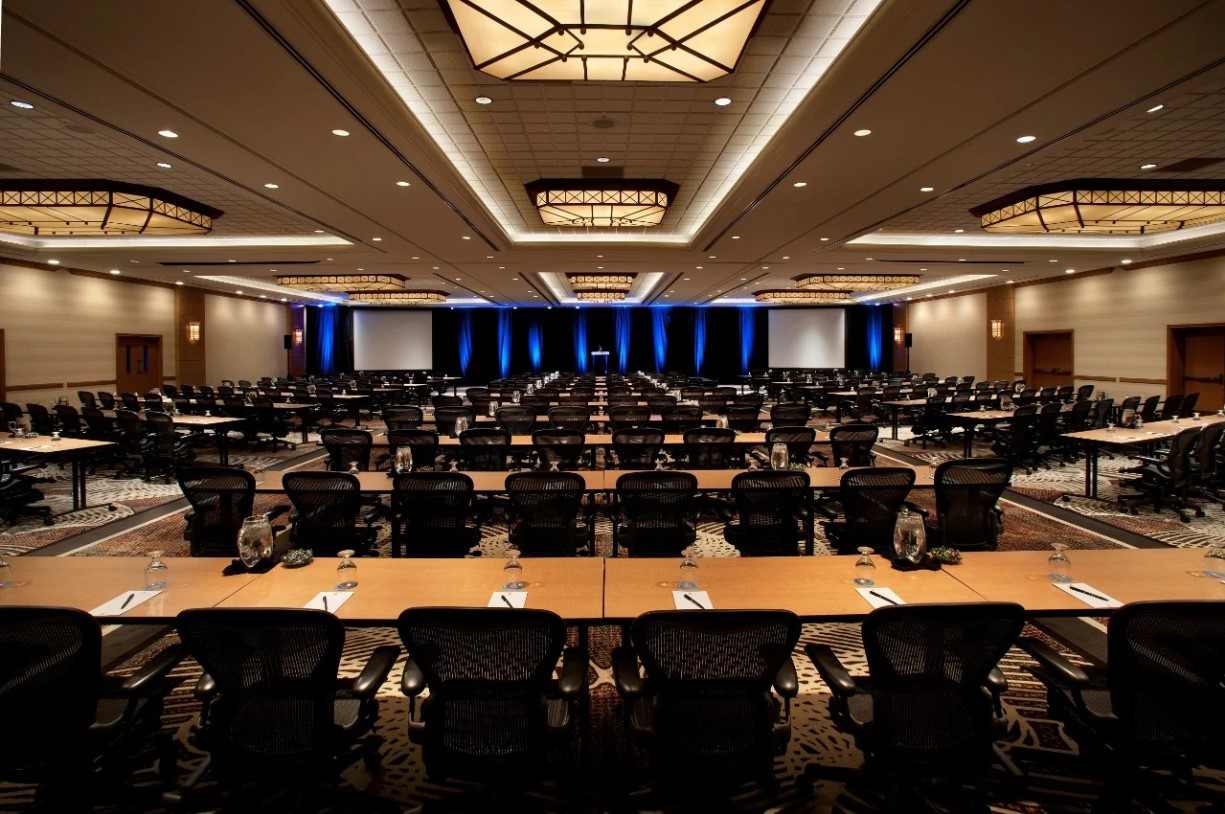 Spacious conference room with multiple tables and chairs