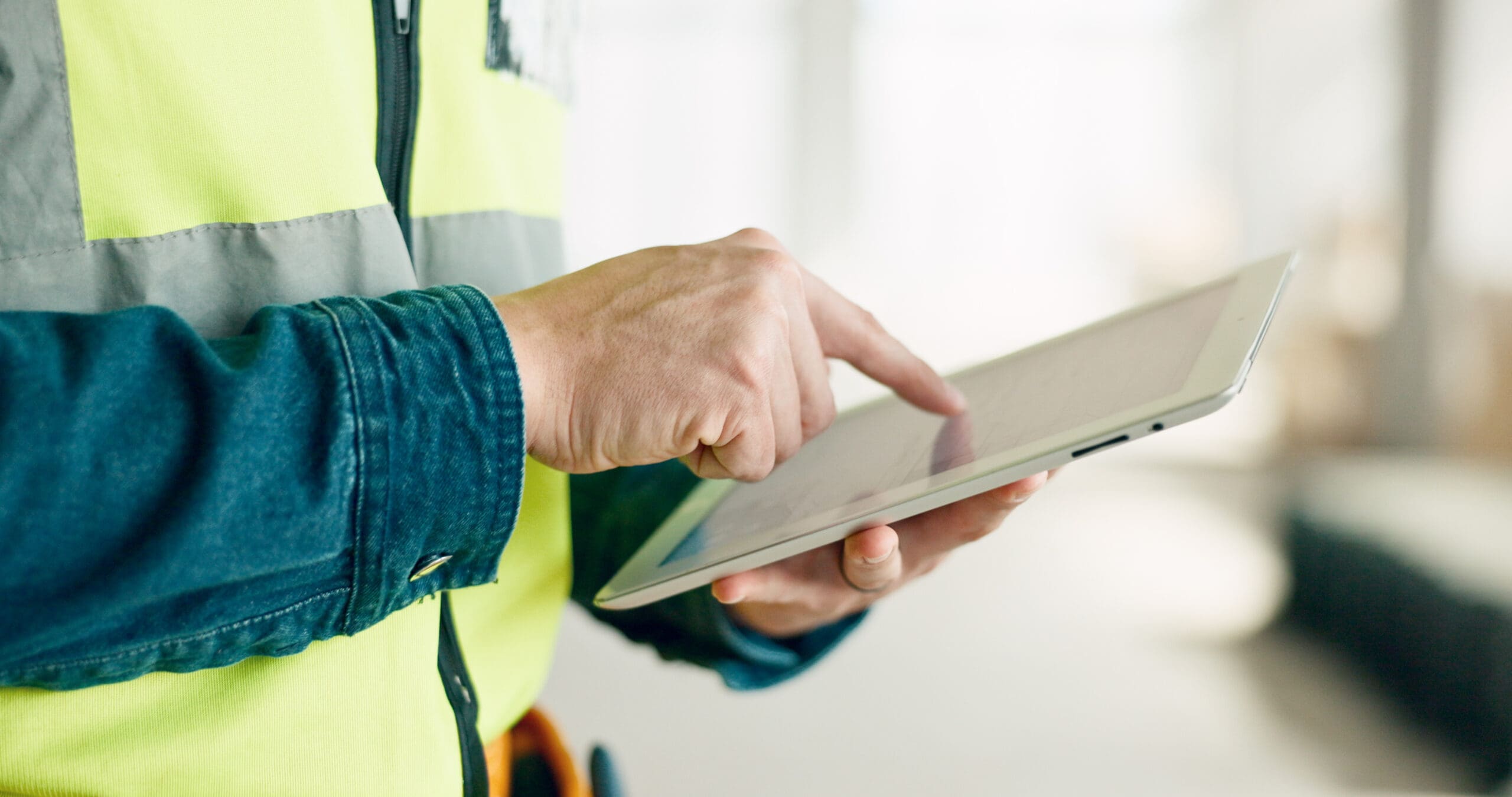 building digital tablet and construction worker