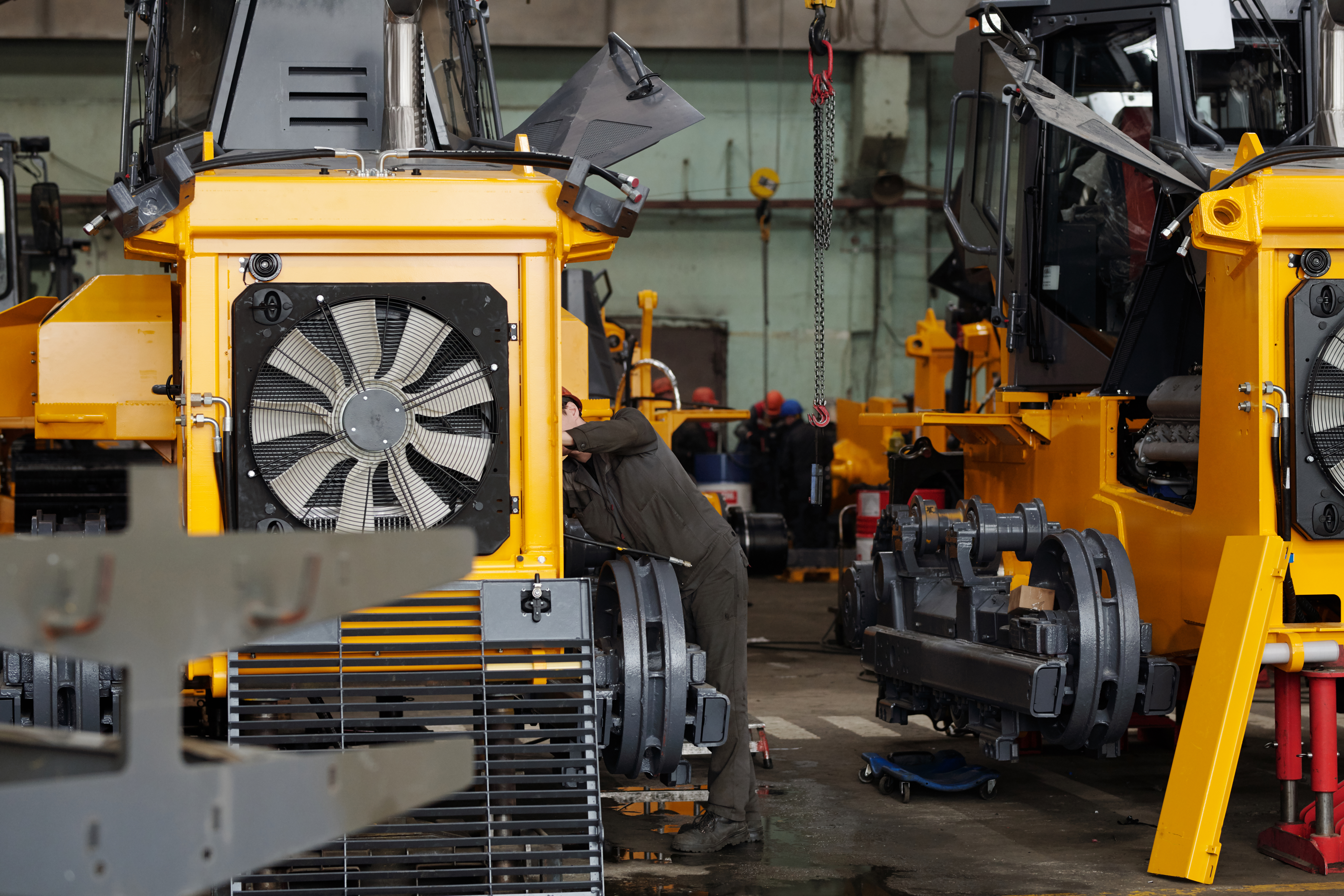 Technician servicing heavy machinery as part of a fleet maintenance system
