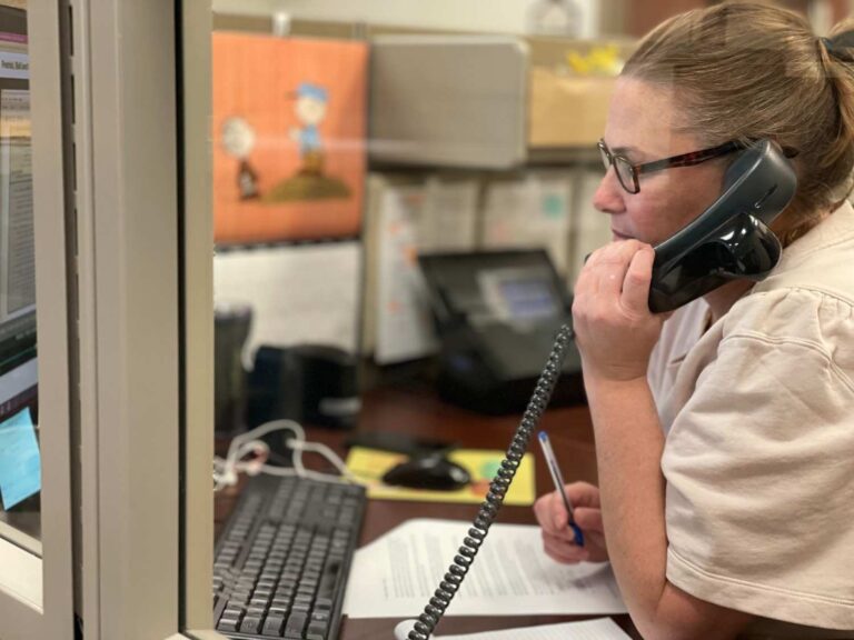 Woman on phone with a customer answering questions for the rental branch