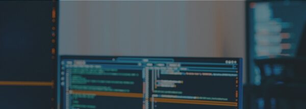 Developer reviewing code across multiple monitors for API integration work